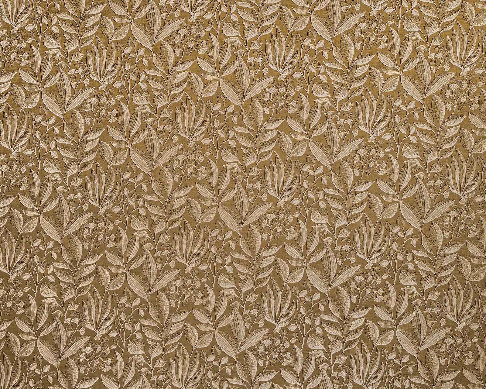 Ochre botanical curtain fabric with layered pale leaf motifs on a warm gold ground