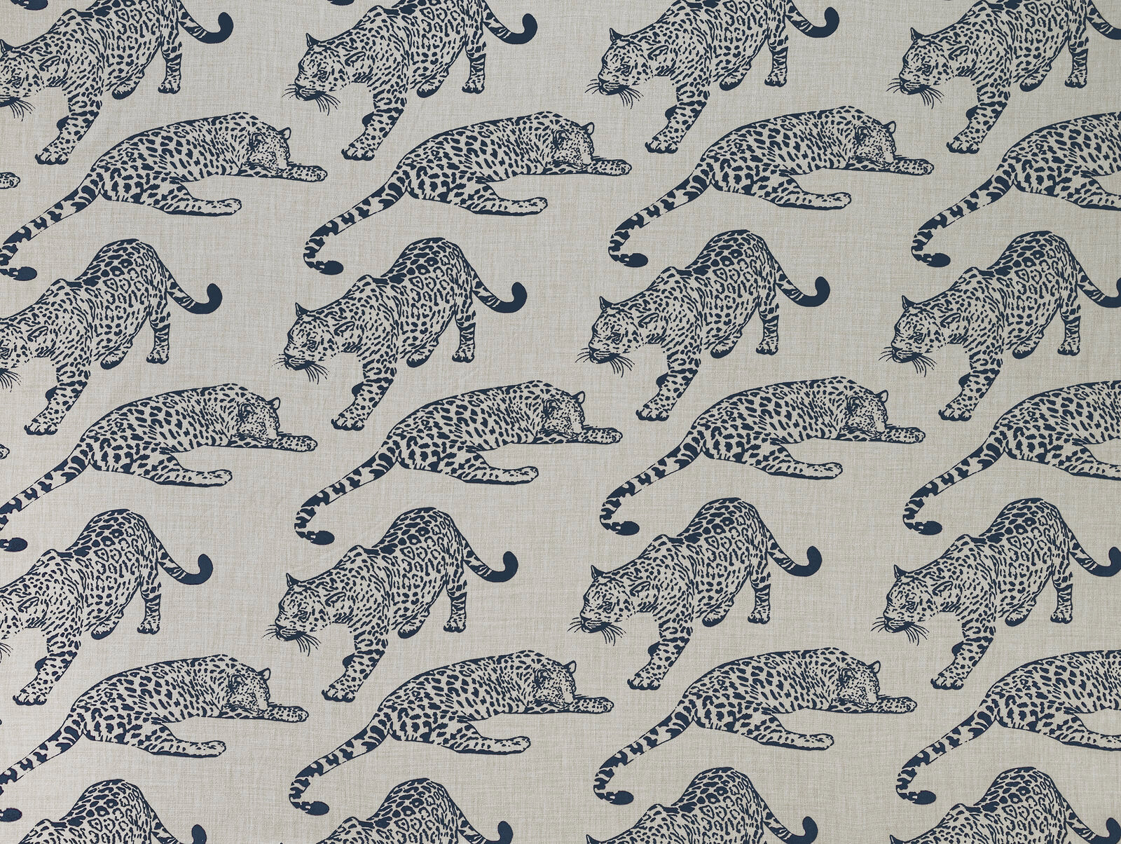 Beige fabric with navy leopard motifs in a large repeating safari print