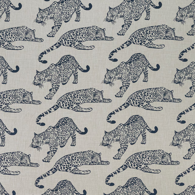 Beige fabric with navy leopard motifs in a large repeating safari print