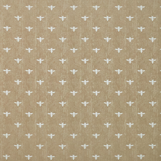 Warm muted gold fabric with small white animal motifs and a lightly textured weave