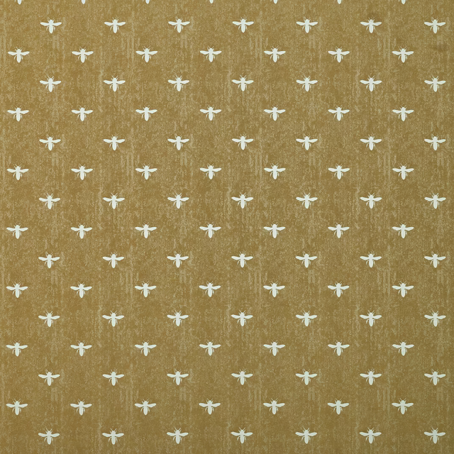 Mustard-gold fabric with tiny cream animal motifs and a textured woven ground