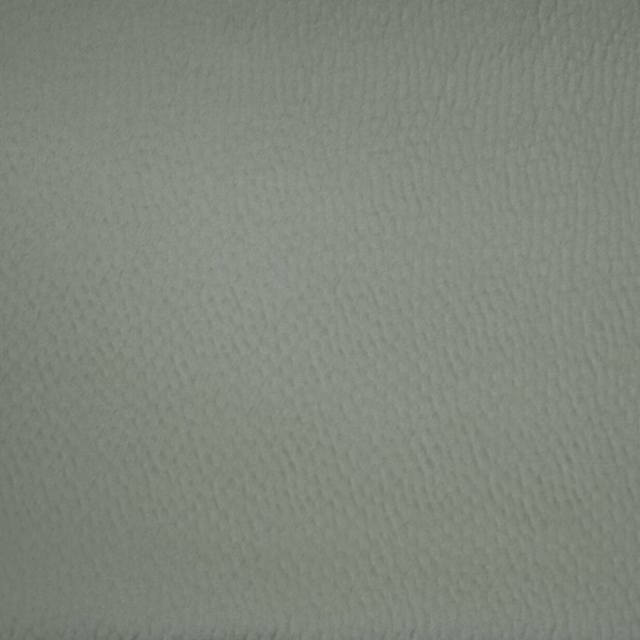 Close-up of soft sage green textured fabric with a fine woven surface