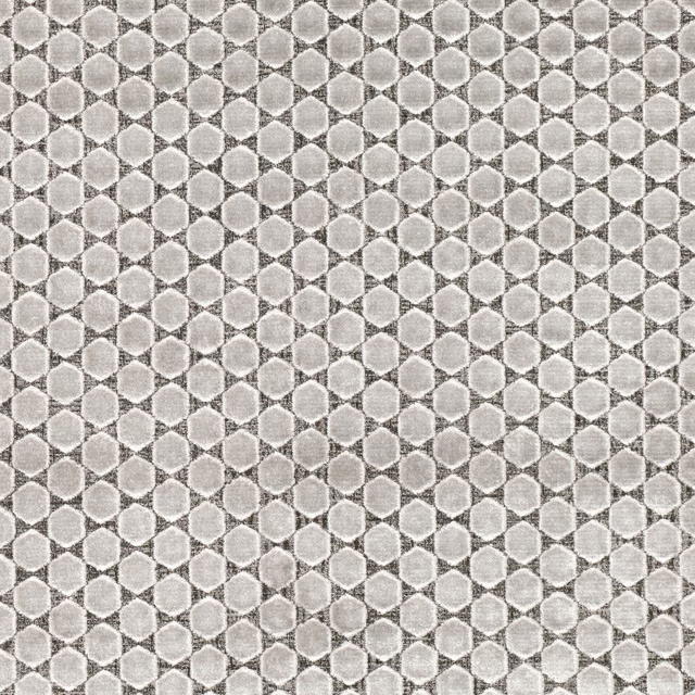 Close view of pale feather-grey geometric weave with rounded motifs and mottled texture