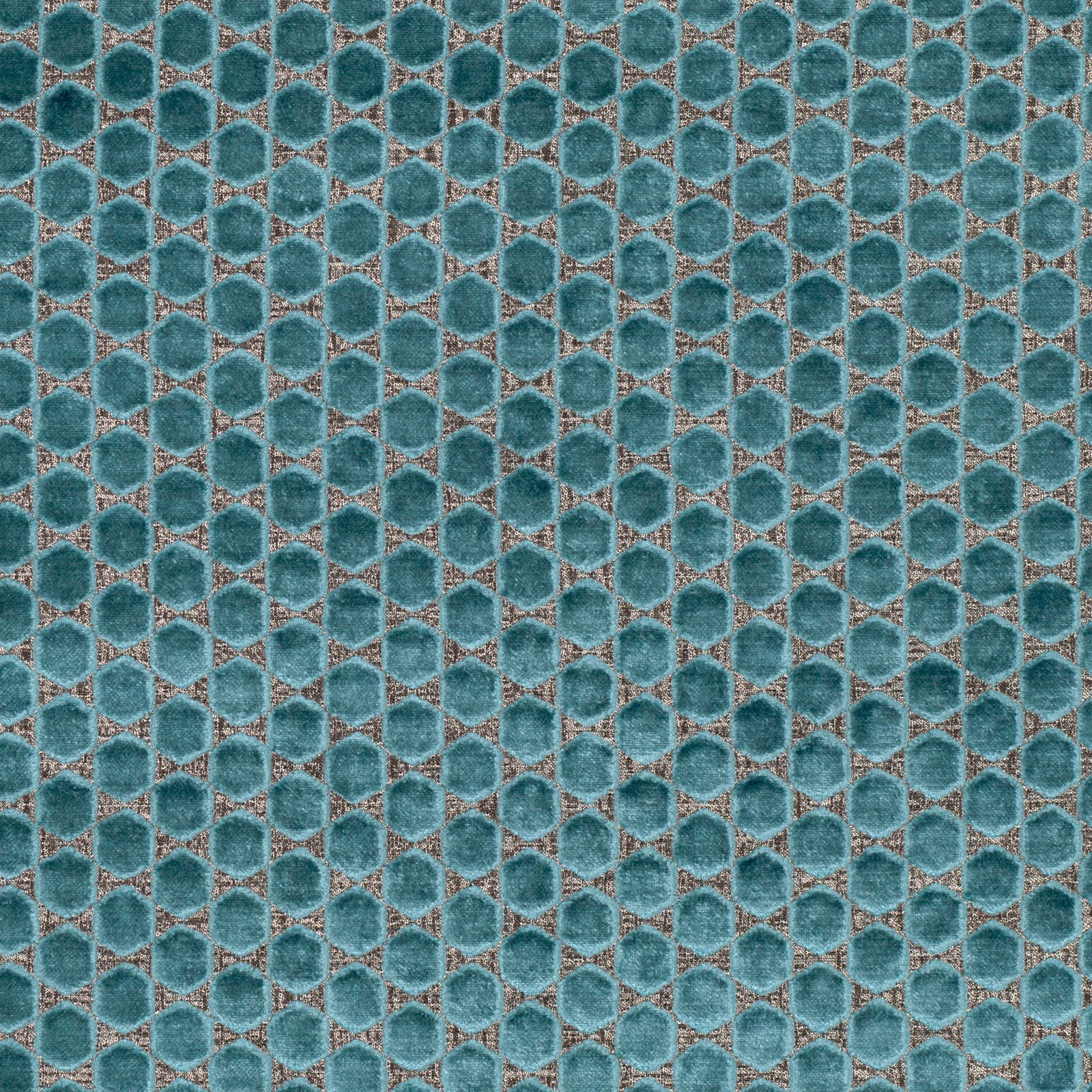 Close view of viridian teal rounded hexagons with warm taupe edging and tactile texture