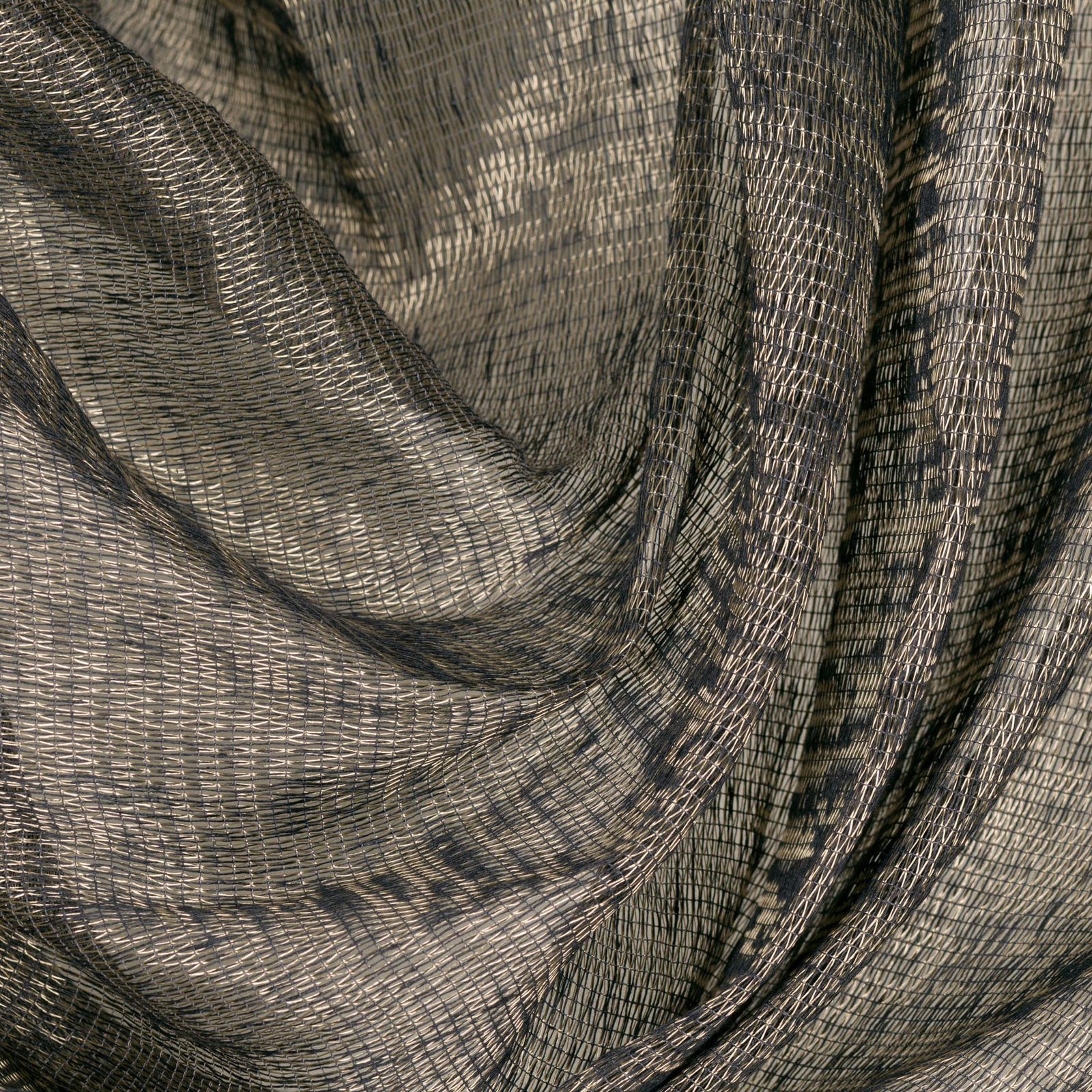 Soft gold and charcoal open weave falling in deep, fluid folds