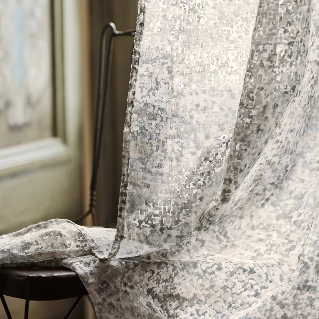 Cool silver-grey sheer fabric with distressed abstract flecks falling in soft translucent folds