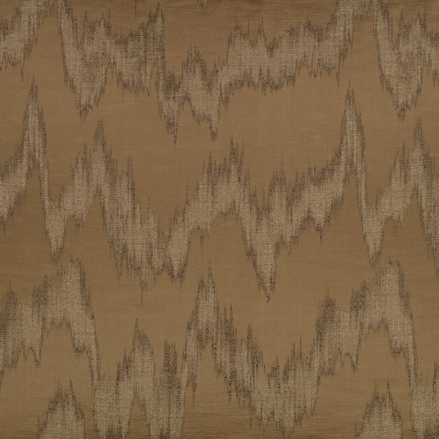Warm spice-brown fabric with jagged beige and charcoal ikat motifs
