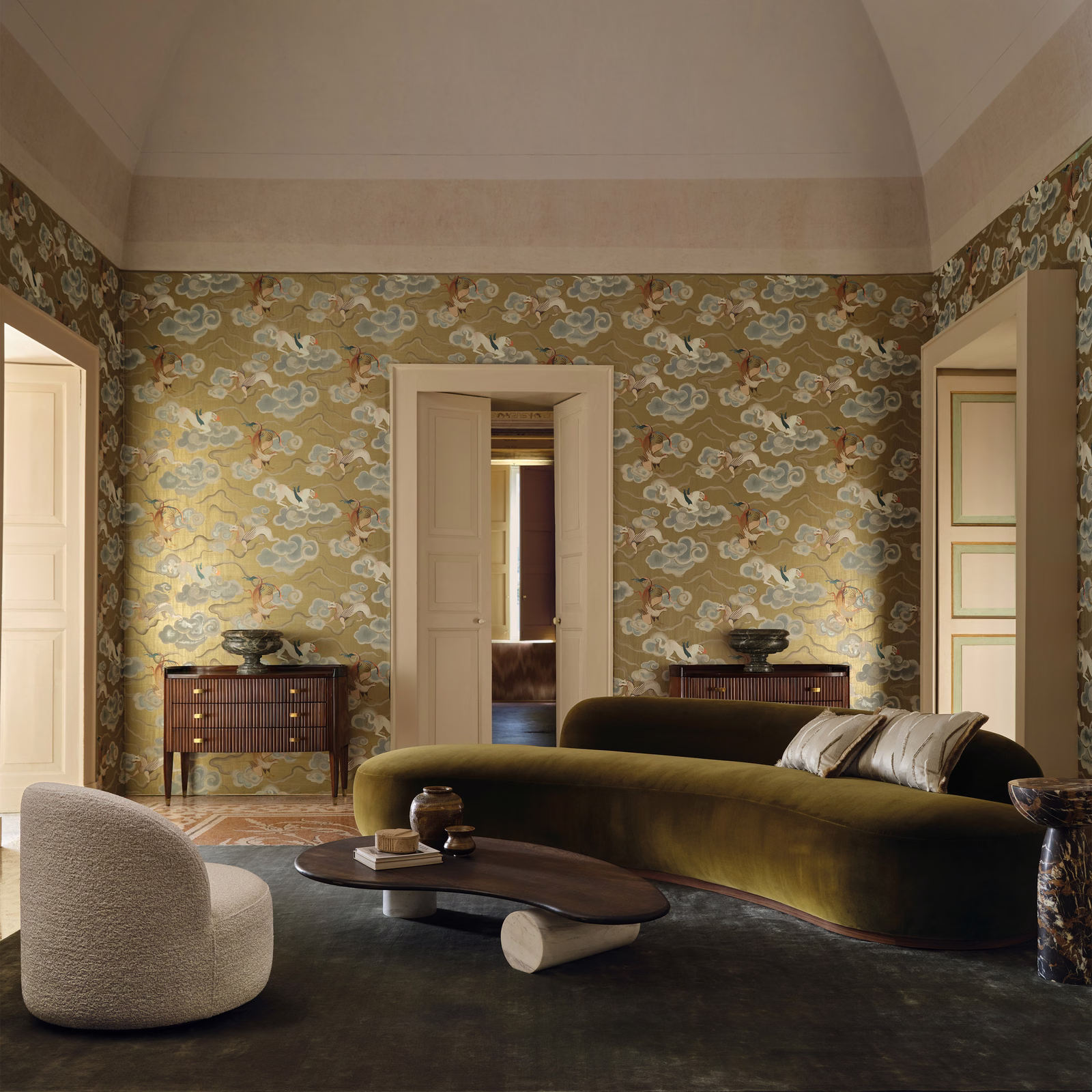Muted olive-gold wallpaper with pale cloud-like motifs and warm gilded accents.