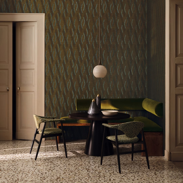 Deep olive-brown wallpaper with slim blue-green angular motifs in a dining room
