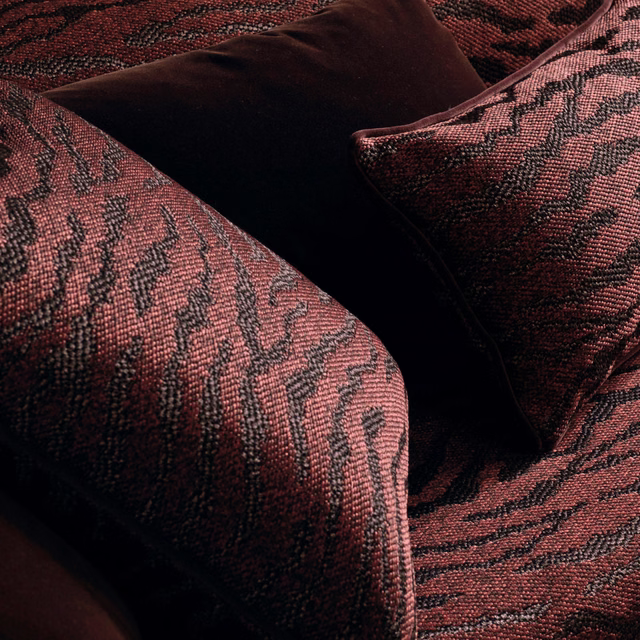 Dusky terracotta upholstery weave with charcoal branching striations and deep ridged texture