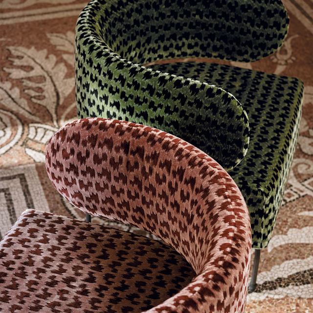 Deep malachite green and black irregular woven motif on a curved chair