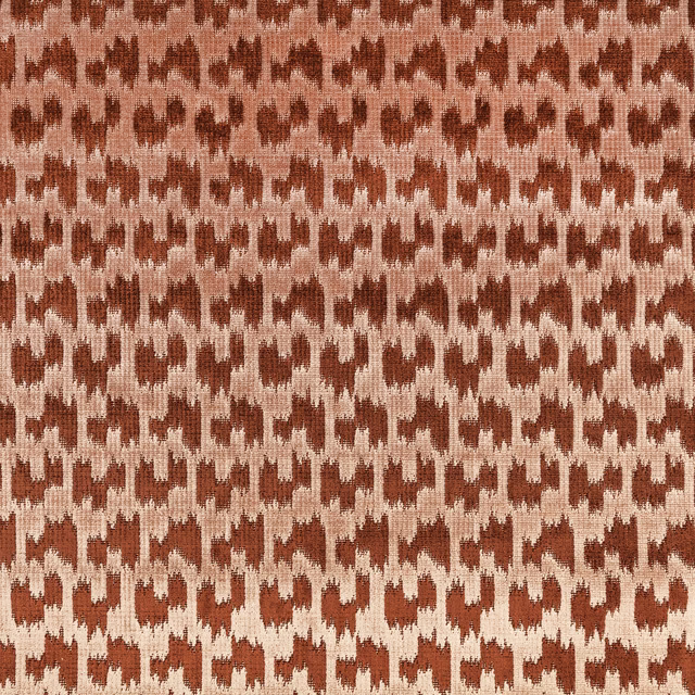 Muted rust and beige ikat-like geometric weave with a tactile surface