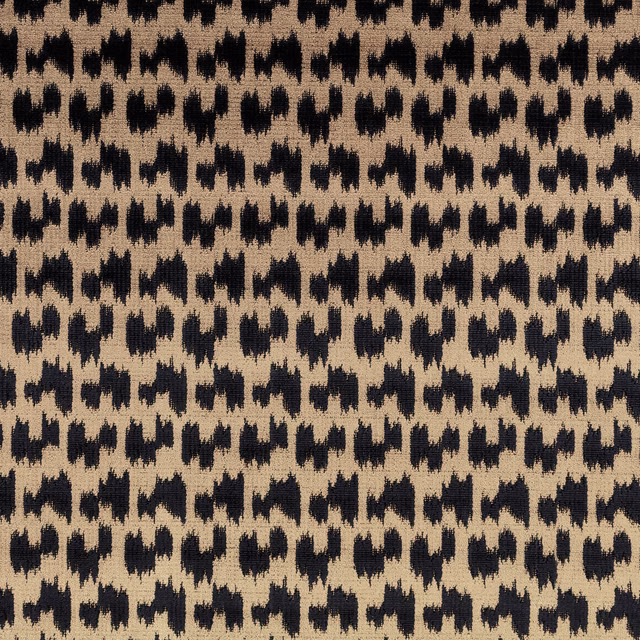 Warm spice woven fabric with repeated irregular black ikat-style motifs and tactile texture