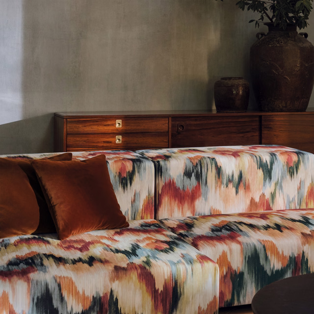 Copper, cream and teal ikat-style upholstery fabric with soft brushstroke texture