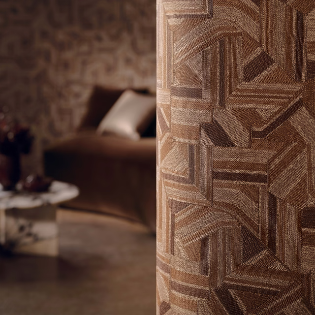 Warm umber wallpaper with interlocking angular blocks and fine taupe linear texture