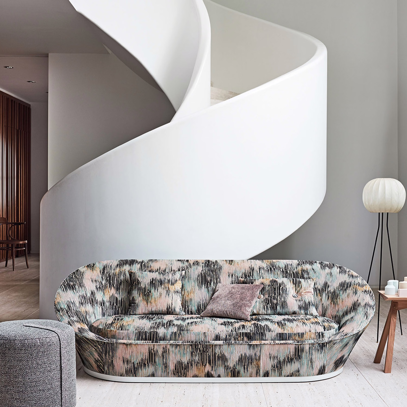 Blush pink jacquard with charcoal and pale blue vertical brush marks on curved sofa