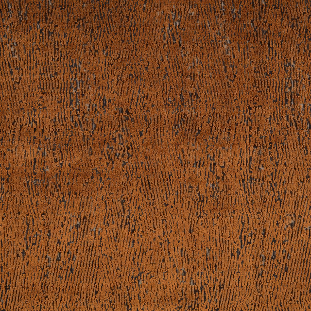 Copper-brown woven textile with dark, irregular vertical flecks and nubby texture