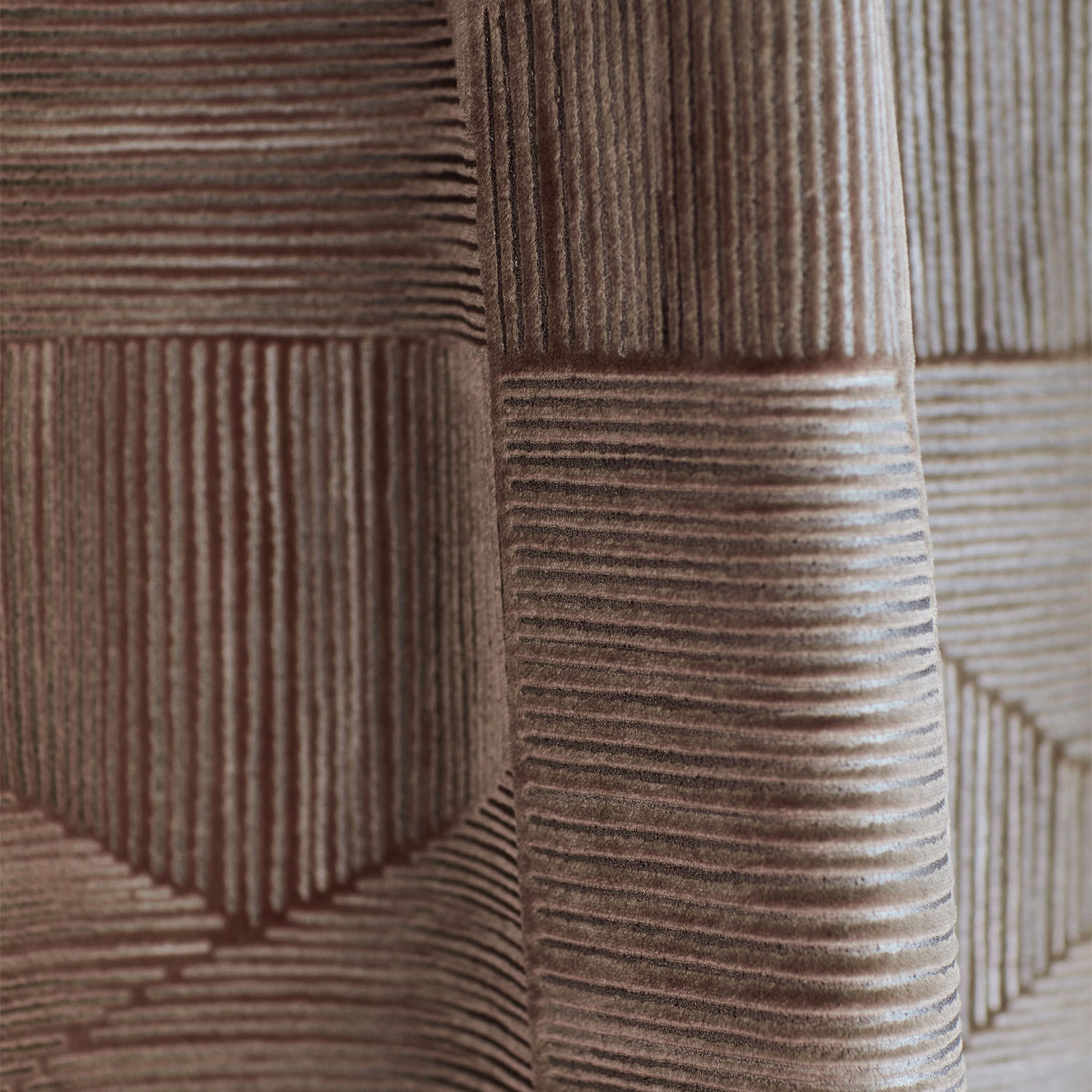 Muted mauve-taupe geometric fabric with raised directional ribs and pale greige highlights