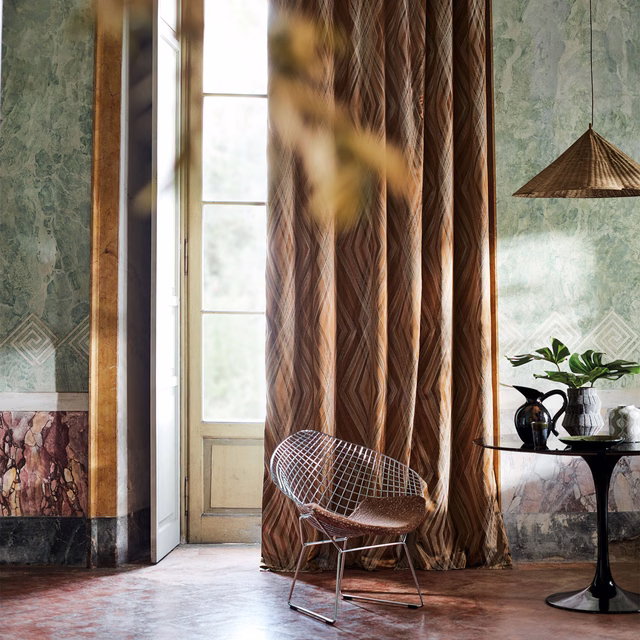 Warm brown geometric curtain with zigzag and diamond motifs in softly textured folds