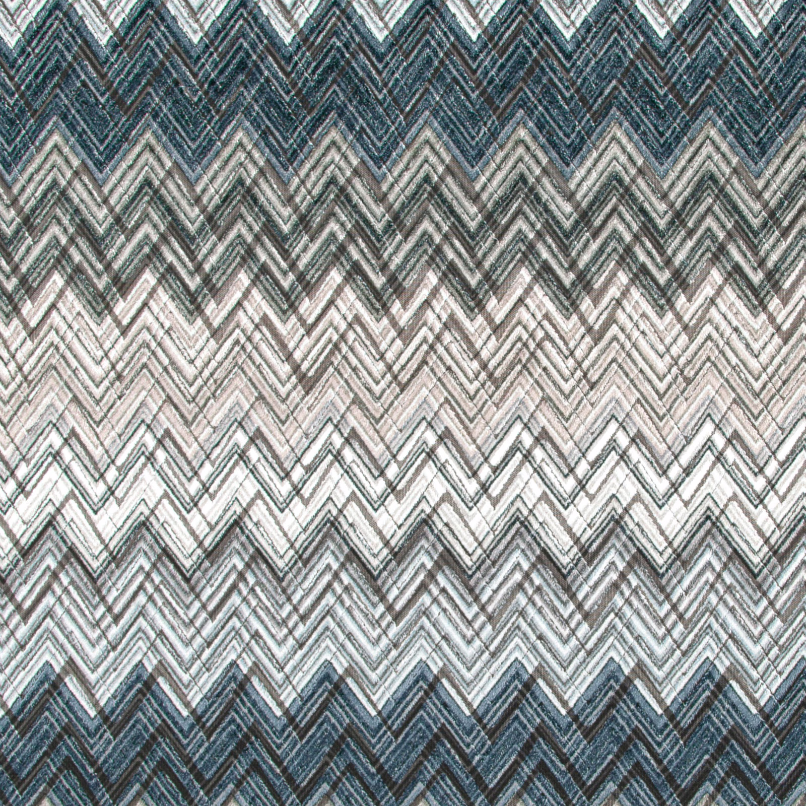 Storm-blue and charcoal chevron textile with pale stone zigzag bands