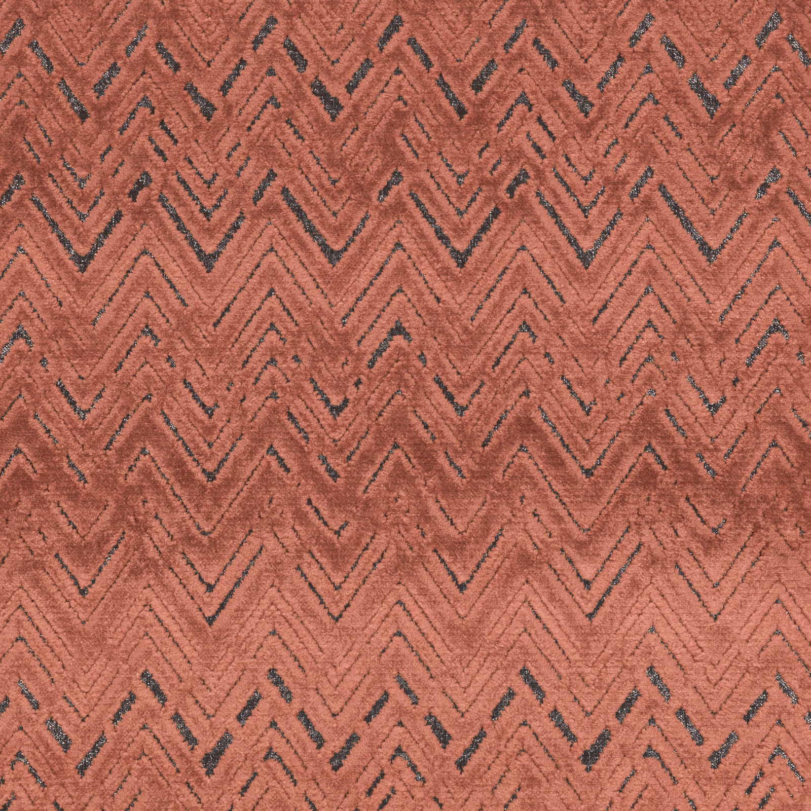 Warm cinnamon-terracotta woven fabric with charcoal chevrons and raised texture