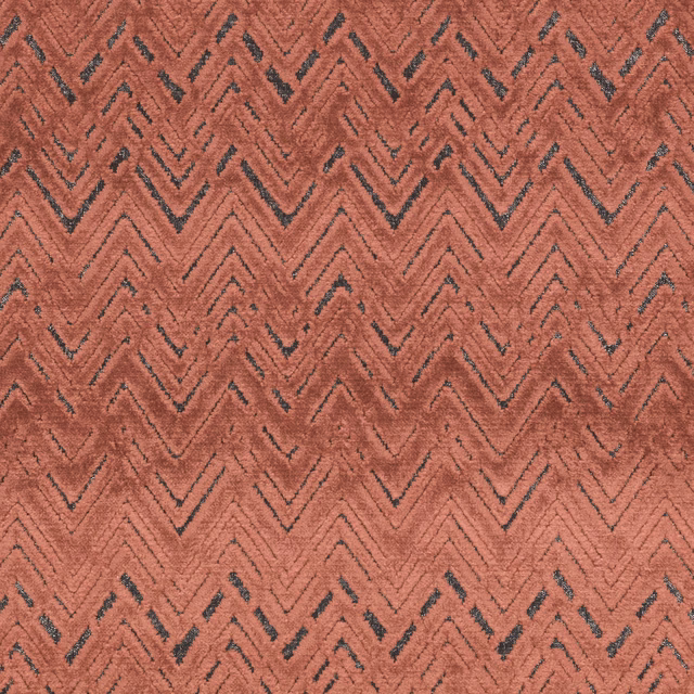 Warm cinnamon-terracotta woven fabric with charcoal chevrons and raised texture