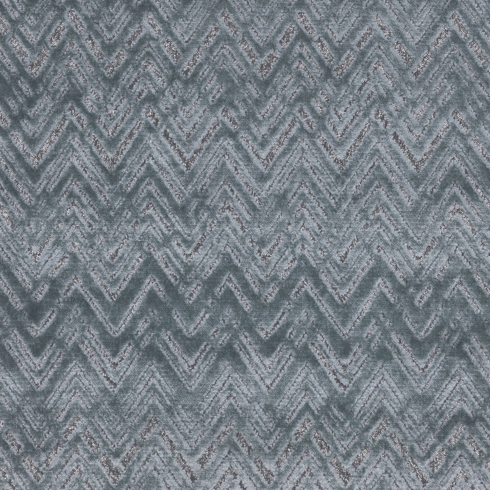 Cool blue-grey textile with mottled woven chevrons and softly broken zigzag texture