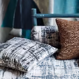 Charcoal and ivory distressed checked upholstery fabric on layered cushions