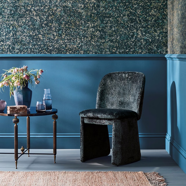 Deep blue-teal wallpaper with dense cream and grey flecks across a dark ground