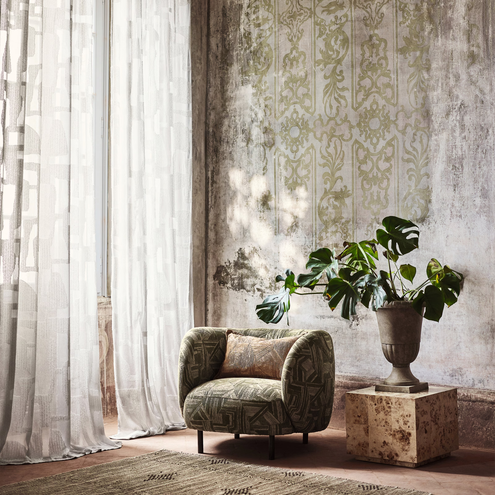 Olive-green geometric upholstery on a rounded armchair, with dark linear motifs
