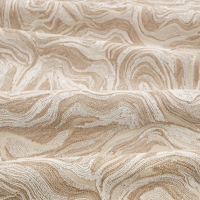 Warm sand-beige textile with broad cream contour bands and raised linear texture