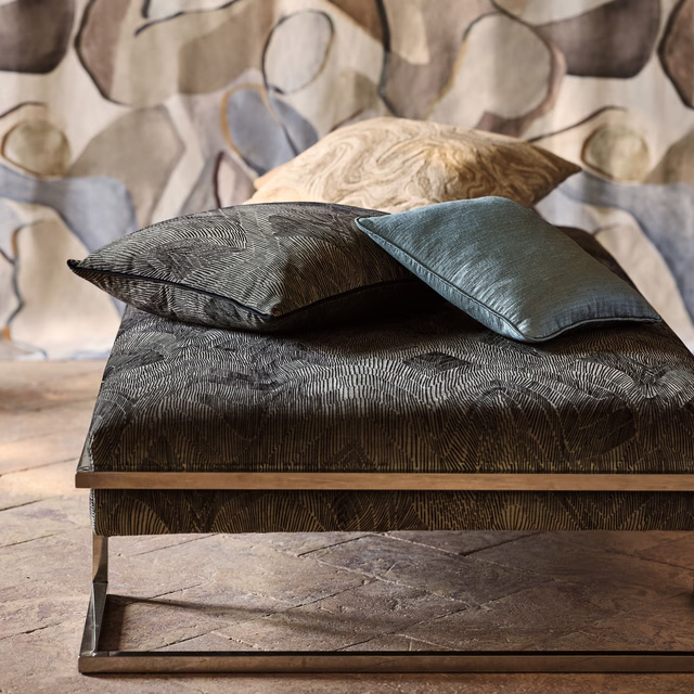 Deep anthracite textile with fine directional lines on a bench and cushions