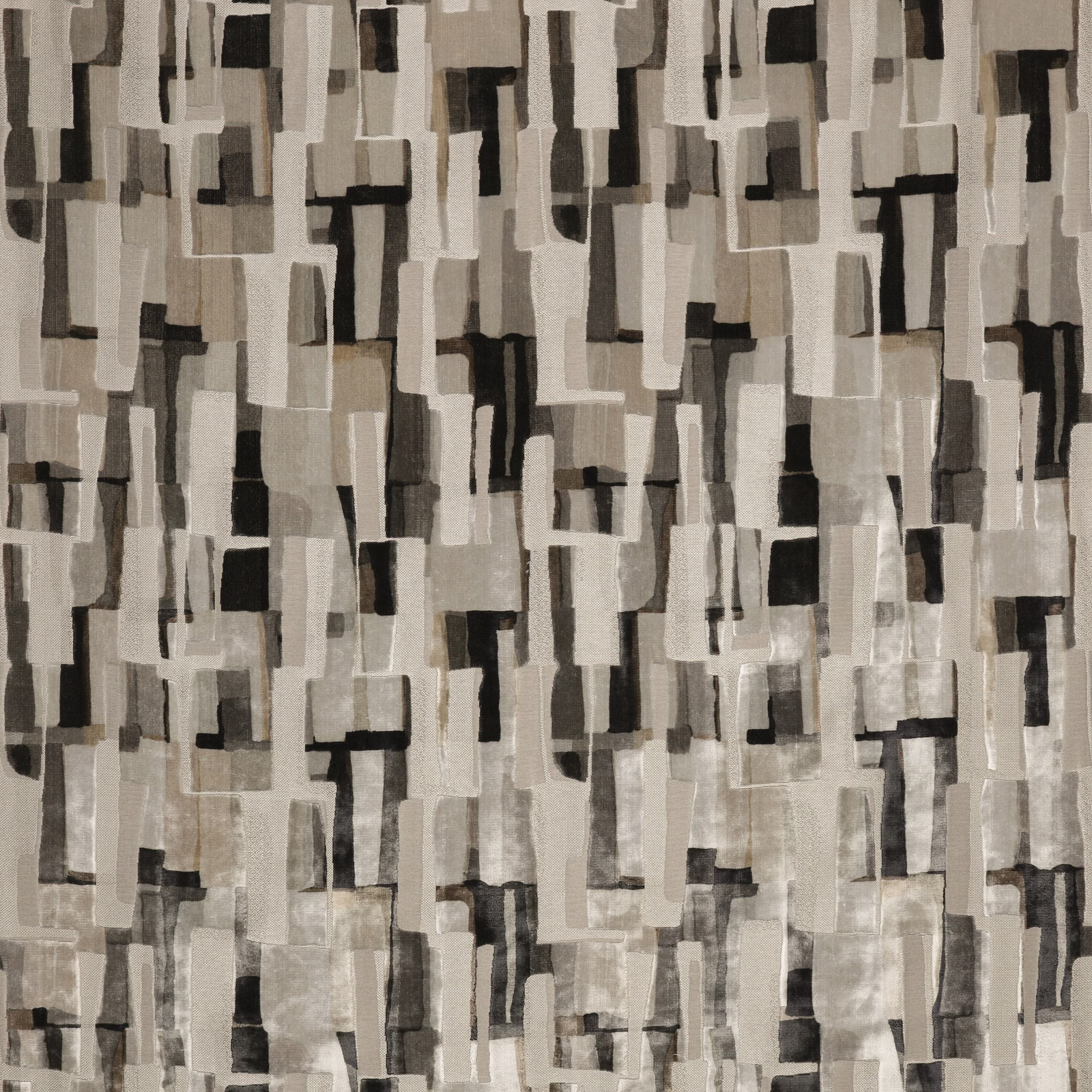 Stone-grey textile with layered charcoal, ivory and taupe rectangular motifs