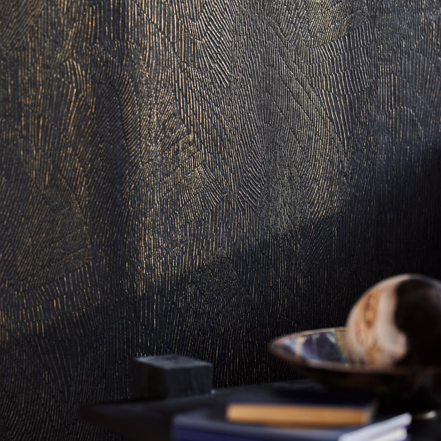 Charcoal-black wallpaper with vertical ribbing and muted bronze leaf-like highlights