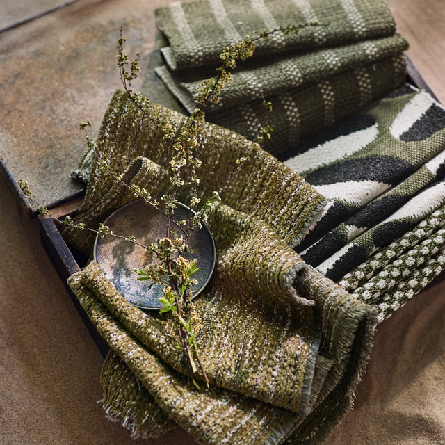 Mossy olive outdoor textile with chunky flecked weave and softly nubby texture