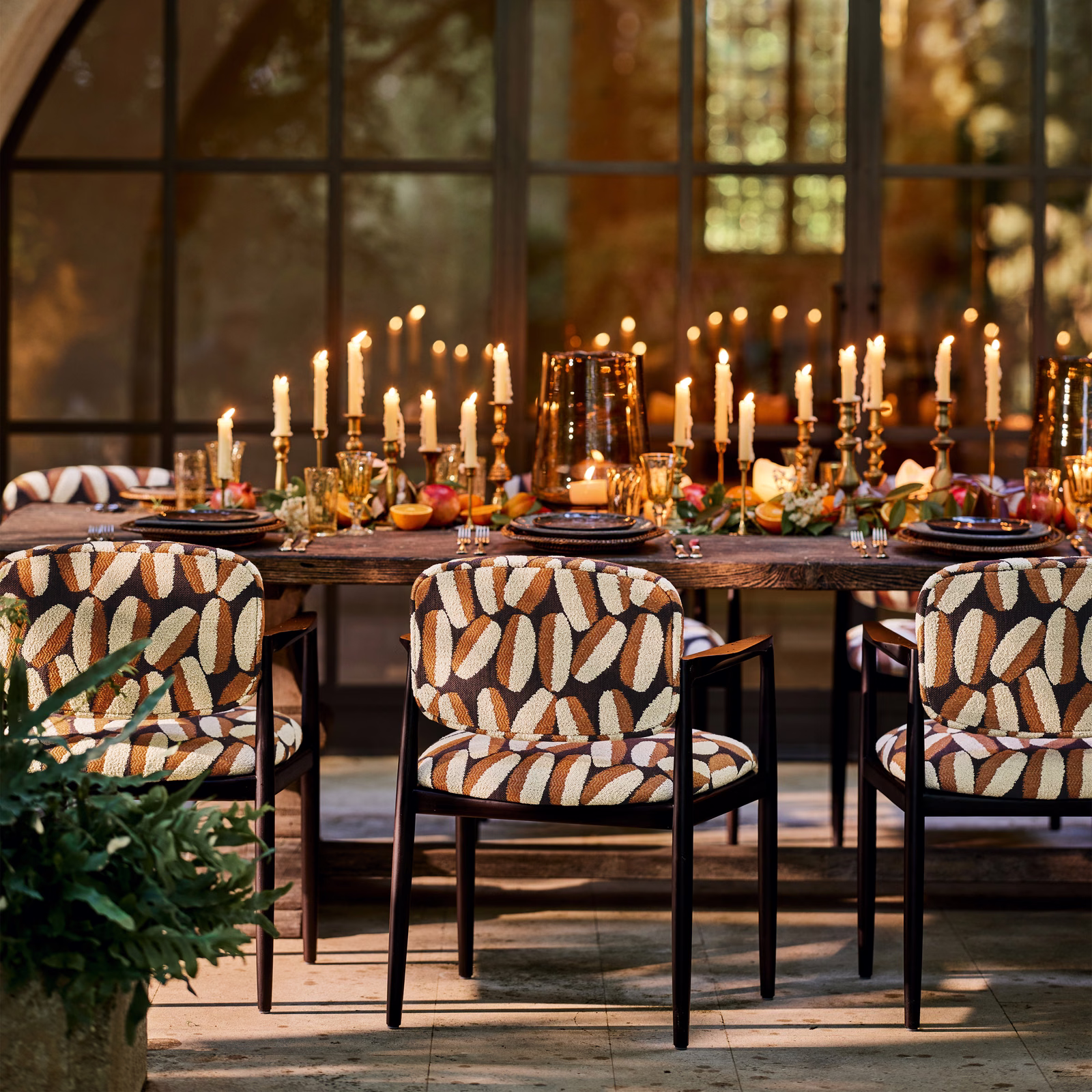 Warm brown and cream oval motifs with olive accents on upholstered dining chairs