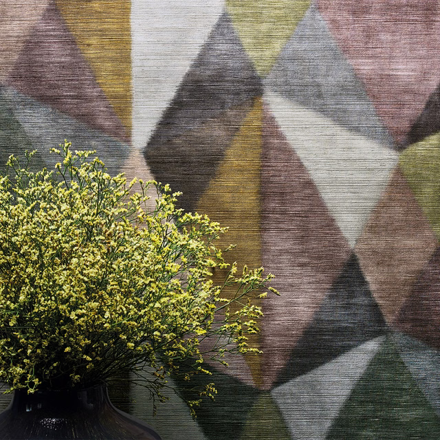 Large geometric wallpaper with mauve, olive, ochre and charcoal triangular facets