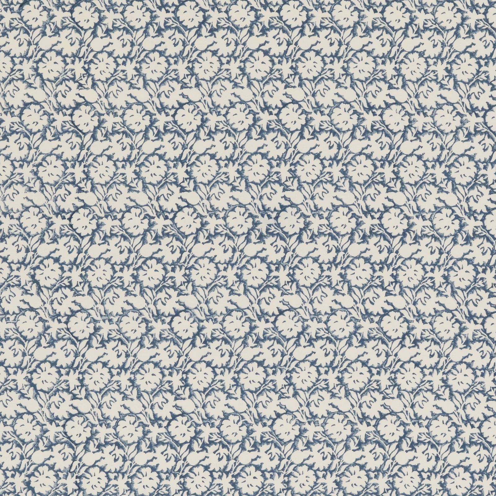 Dense muted indigo flowers and leafy sprigs on a warm cream cotton ground