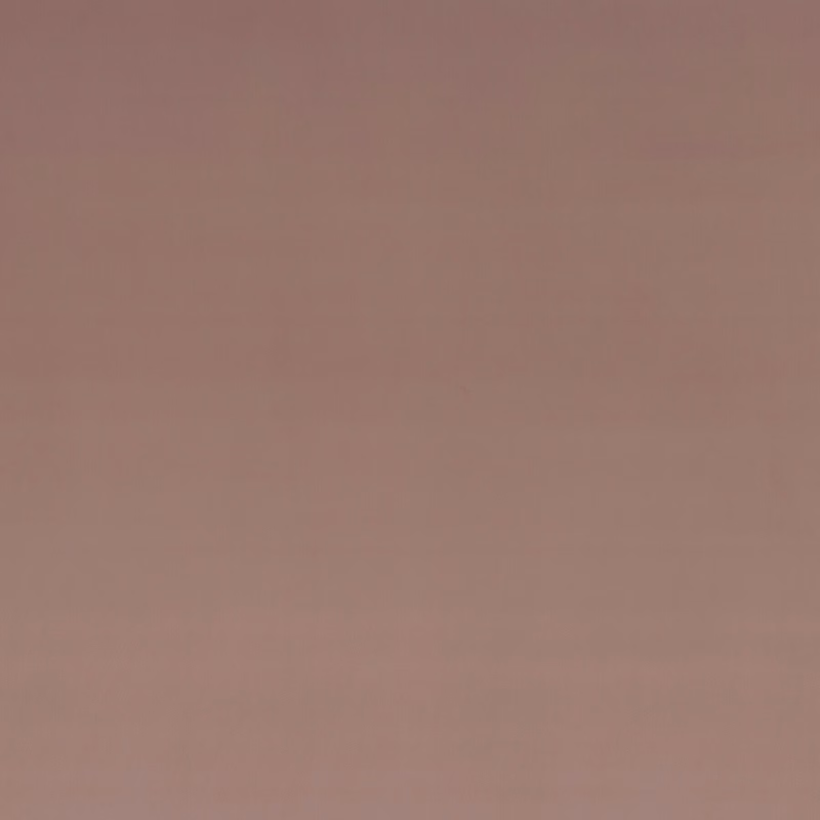Close-up of plain dusty blush pink velvet with a softly shifting low sheen