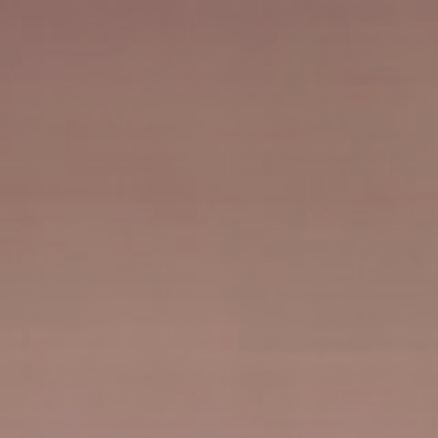 Close-up of plain dusty blush pink velvet with a softly shifting low sheen