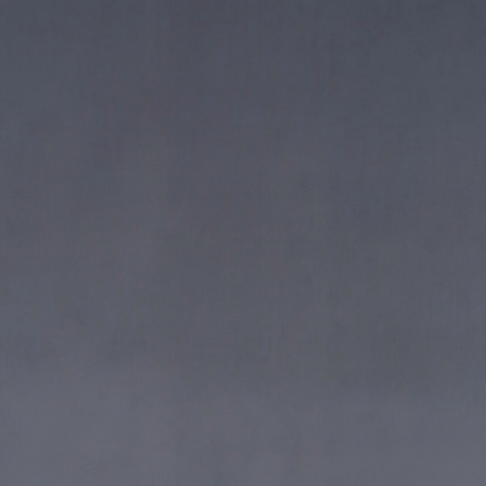 Close-up of cool graphite grey velvet showing soft directional nap and subtle tonal sheen