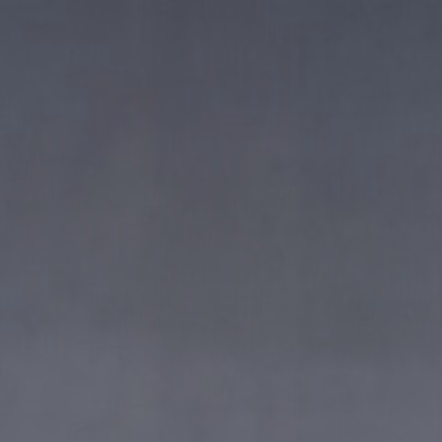 Close-up of cool graphite grey velvet showing soft directional nap and subtle tonal sheen