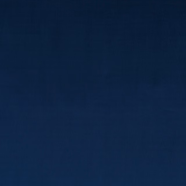 Deep indigo velvet with subtle nap shading and a soft, plain surface