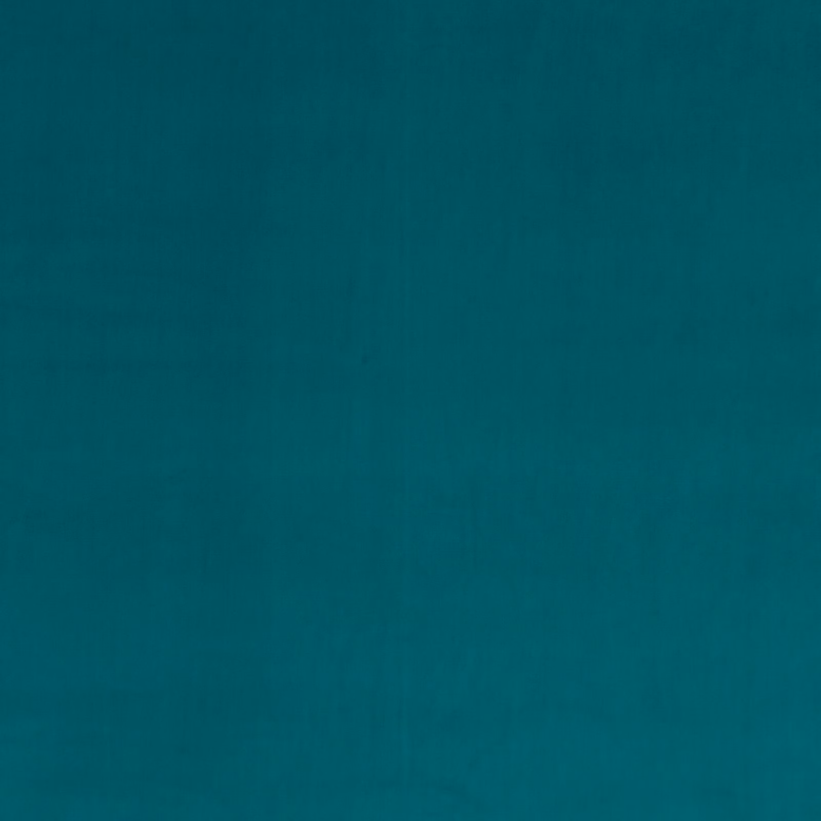 Close-up of deep peacock teal velvet showing a smooth, subtly directional pile