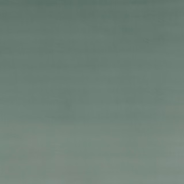 Muted sea-foam green velvet with softly directional nap and no visible motif