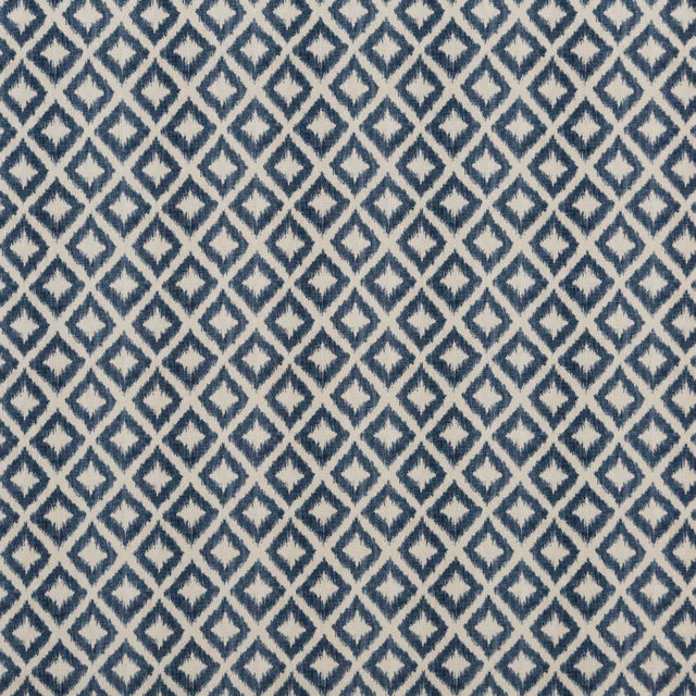 Close-up of muted indigo diamond lattice woven over a warm ivory ground