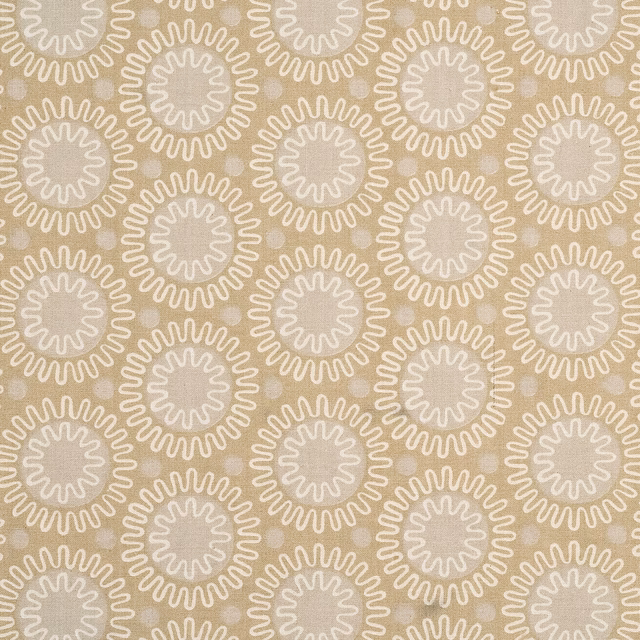 Warm biscuit cotton with ivory looping sunburst medallions in a compact repeat