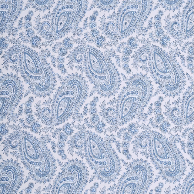 Cool Delft-blue paisleys and fine dotted tracery repeat across a pale paper ground