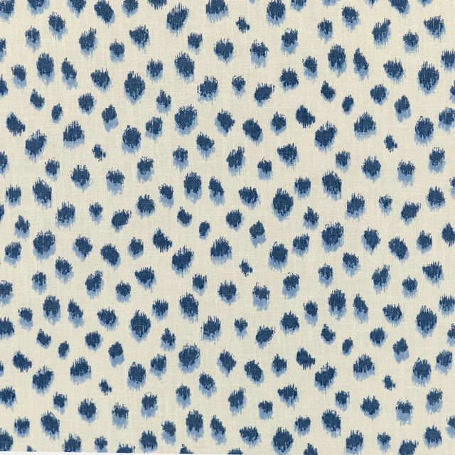 Cream woven fabric with scattered indigo brush-mark motifs and fine vertical texture