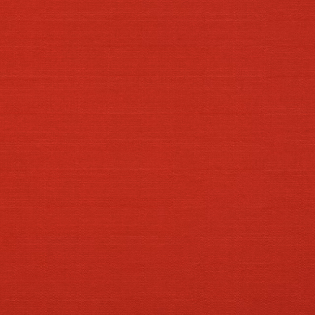 Close-up of saturated pillar-box red fabric with a fine horizontal woven texture